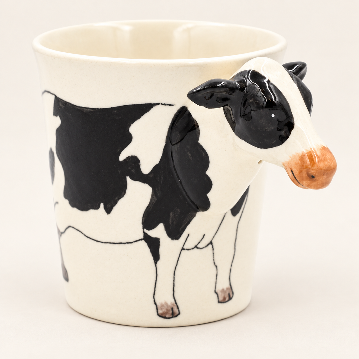 Cow Ceramic Mug on a warm ivory background