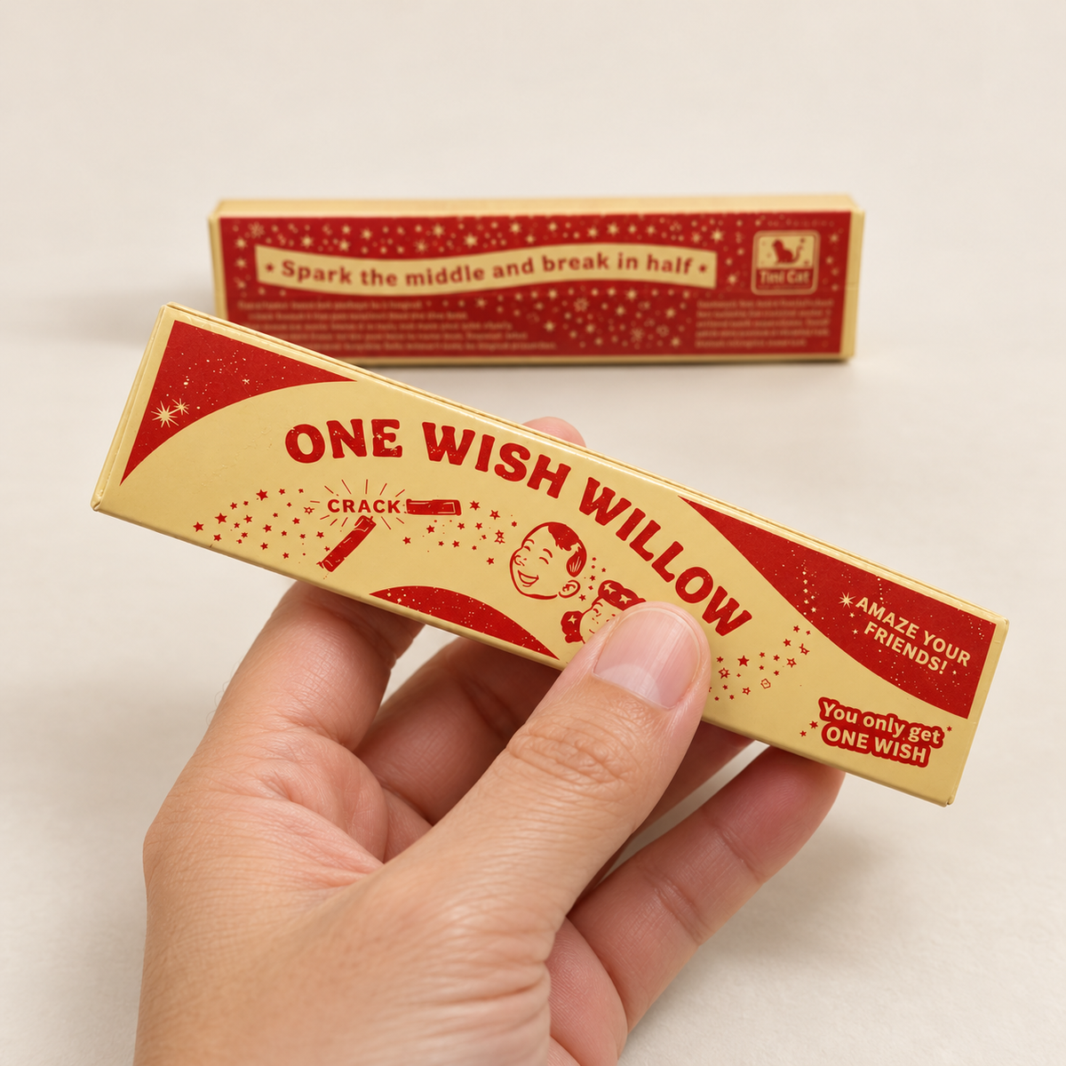 ONE WISH WILLOW vintage-style red and cream box held in a bare hand for scale