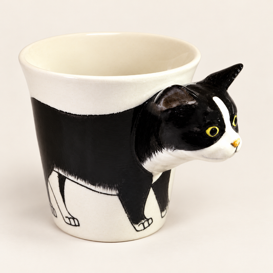 Tuxedo Cat Ceramic Mug on a warm ivory background