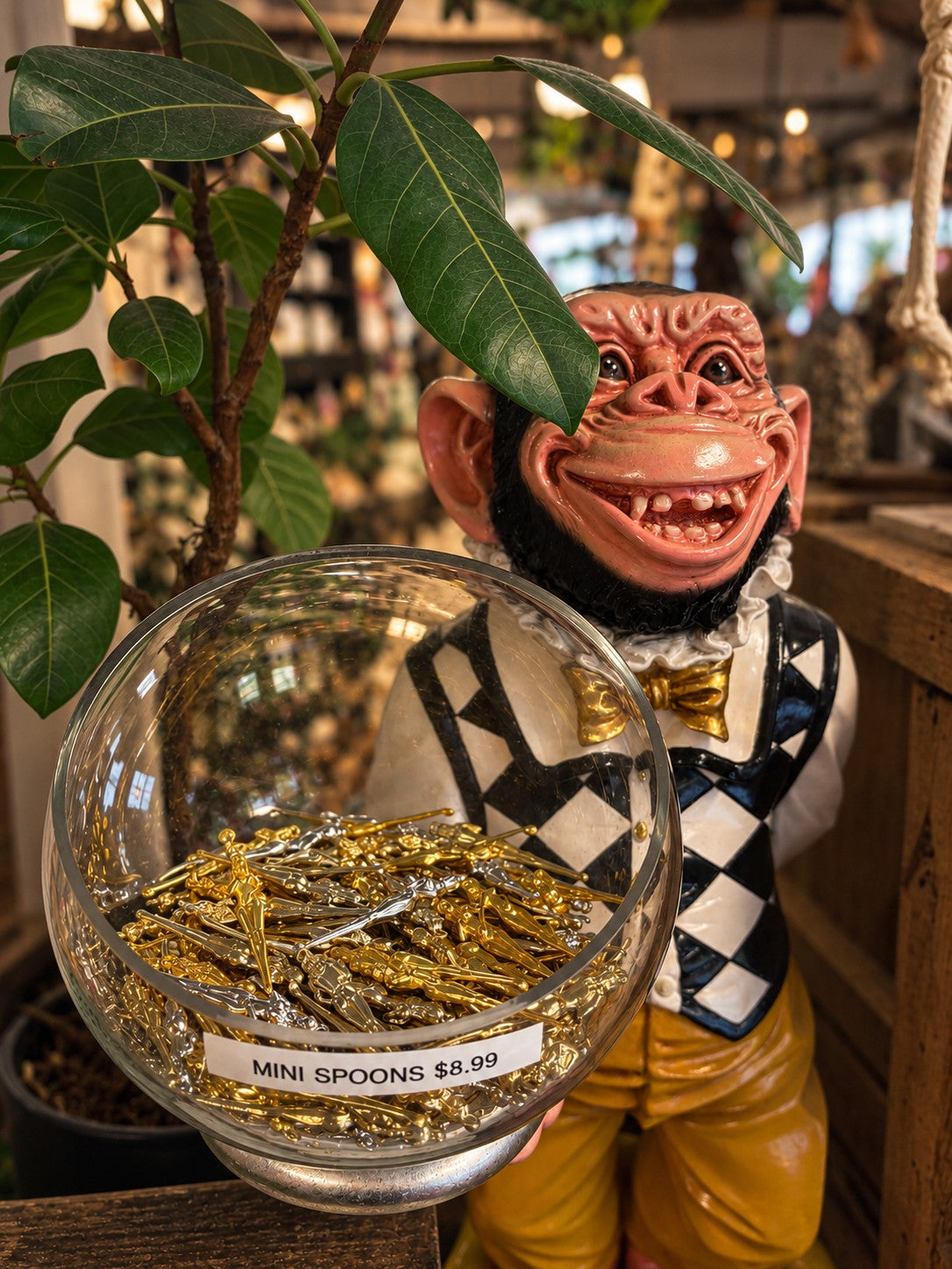 The smiling monkey display with a bowl of miniature spoons